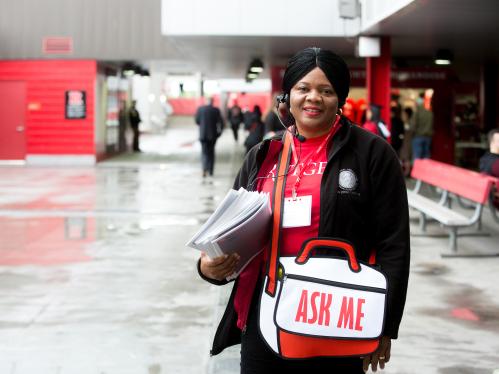Women with 'ask me' sign